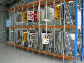 Numerous traffic signs stored inside a satellite depot